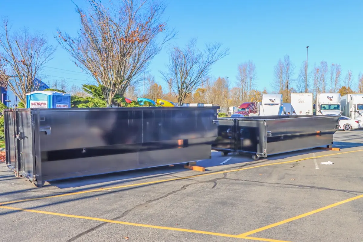 Professional dumpster rental service with roll-off container on residential driveway in Oxnard